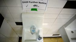 A sign is seen next to a water dispenser at North Western High School in Flint, a city struggling with the effects of lead-poisoned drinking water in Michigan, May 4, 2016.