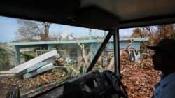 Luis Menendez, a mail man for the U.S. Postal Service, delivers mail at an area affected by Hurricane Maria in the island of Vieques, Puerto Rico.
