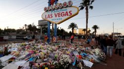 The "Welcome to Las Vegas" sign is surrounded by flowers and items, left after the October 1 mass shooting, in Las Vegas, Nevada U.S. October 9, 2017. REUTERS/Las Vegas Sun/Steve Marcus
