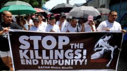 FILE PHOTO: Relatives and loved ones of Leover Miranda, 39, a drug-related killings victim, hold a streamer calling to stop the continuing rise of killings due to the President Rodrigo Duterte's ruthless war on drugs, during a funeral march at the north cemetery in metro Manila, Philippines August 20, 2017. REUTERS/Romeo Ranoco