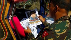 Soldiers distribute pictures of a member of extremist group Abu Sayyaf Isnilon Hapilon, who has a U.S. government bounty of $5 million for his capture, in Butig, Lanao del Sur in southern Philippines February 1, 2017.