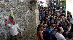 Venezuelan citizens wait in line at a polling station during a nationwide election for new governors in Caracas, Venezuela. REUTERS/Ricardo Moraes