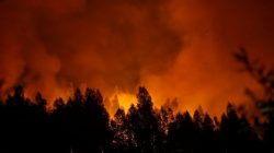 Smoke and flames from a forest fire are seen near Lousa, Portugal, October 16, 2017. REUTERS/Pedro Nunes