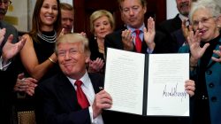 FILE PHOTO: U.S. President Donald Trump smiles after signing an Executive Order to make it easier for Americans to buy bare-bone health insurance plans and circumvent Obamacare rules at the White House in Washington, U.S., October 12, 2017. REUTERS/Kevin Lamarque/File Photo