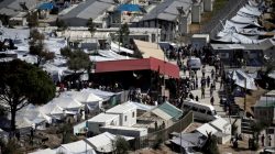 : Refugees and migrants line up for food distribution at the Moria migrant camp on the island of Lesbos, Greece October 6, 2016.