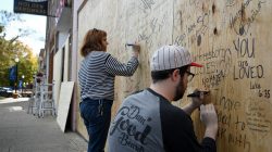 Local residents write on boards installed to protect a business during tomorrow's White Lives Matter rally in Murfreesboro, Tennessee, U.S. October 27, 2017. REUTERS/Bryan Woolston