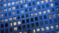Office lights are on at dusk in the Canary Wharf financial district, London, Britain,
