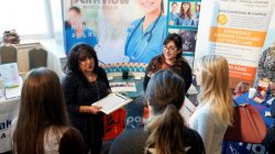 FILE PHOTO: Job seekers listen to a recruiter at the Colorado Hospital Association job fair in Denver, Colorado, U.S. on October 4, 2017