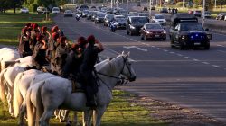 The funeral motorcade of the five Argentine citizens who were killed in the truck attack in New York on October 31 passes by as mounted policemen salute in Buenos Aires, Argentina November 6, 2017.