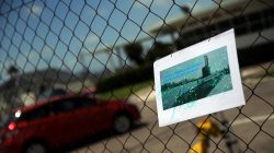 A car enters the Argentine Naval Base where the missing at sea ARA San Juan submarine sailed from as a picture of it hangs on a fence in Mar del Plata, Argentina November 19, 2017.