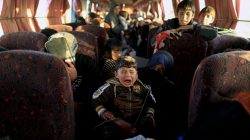 A boy who just fled a village controlled by Islamic State fighters cries as he sits with his family on a bus before heading to the camp at Hammam Ali south of Mosul, Iraq, February 22, 2017.