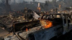 A home's remains are seen, next to a burnt out truck, after they were destroyed, during a wind-driven wildfire in Ventura.