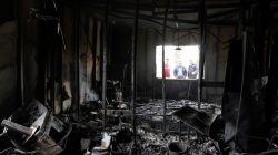 People are seen outside the Directorate of province building after it was set on fire by Kurdish protesters in Pera magroon district in Sulaimaniyah, Iraq December 19,