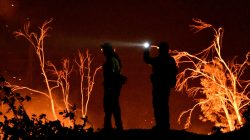 Firefighters keep watch on the Thomas wildfire in the hills and canyons outside Montecito, California, U.S., December 16, 2017.