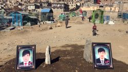 The photos of two brothers, who were killed during yesterday's suicide attack at a Shi'ite cultural centre, are seen on their graves in Kabul, Afghanistan. December 29, 2017.
