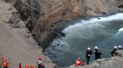 Rescue workers and police work at the scene after a bus crashed with a truck and careened off a cliff along a sharply curving highway north of Lima, Peru, January 2, 2018. REUTERS/Guadalupe Pardo