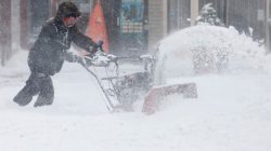 A man uses a snowblower to clear snow from a street during a snowstorm in Port Washington, New York, U.S. January 4, 2018.