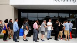 Job seekers line up to apply during "Amazon Jobs Day," a job fair being held at 10 fulfillment centers across the United States aimed at filling more than 50,000 jobs, at the Amazon.com Fulfillment Center in Fall River, Massachusetts, U.S., August 2, 2017.