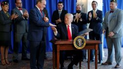 President Donald Trump shakes hands with Secretary of Veterans Affairs David Shulkin (L) after signing the Veterans Affairs Choice and Quality Employment Act at Trump's golf estate in Bedminster, New Jersey U.S. August 12, 2017.