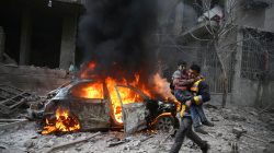 A Syria Civil Defence member carries a wounded child in the besieged town of Hamoria, Eastern Ghouta, in Damascus, Syria Janauary 6, 2018.