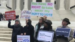 Activists rally outside the U.S. Supreme Court ahead of arguments in a key voting rights case involving a challenge to the OhioÕs policy of purging infrequent voters from voter registration rolls, in Washington, U.S., January 10, 2018.