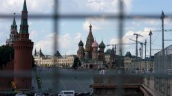 A view through a construction fence shows the Kremlin towers and St. Basil's Cathedral on a hot summer day in central Moscow, Russia, July 1, 2016.