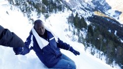 Abdullhai, 38, from Guinea, is helped by a friend as they try to cross part of the Alps mountain range from Italy into France, near the town of Bardonecchia, in northern Italy, December 21, 2017.