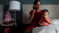 Puerto Rican Debora Oquendo, 43, makes a phone call to a doctor for her 10-month-old daughter in a hotel room where she lives, in Orlando, Florida, U.S., December 4, 2017.