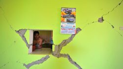 A man observes a damage building after a strong magnitude 7.1 earthquake struck the coast of southern Peru, in Acari, Arequipa , Peru, January 14, 2018.