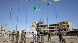 Fighters of Syrian Democratic Forces place flags at Naim Square after liberating Raqqa, Syria October 18, 2017.