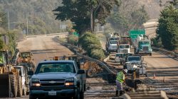 Workers on the 101 Highway clear mud and debris from the roadway after a mudslide in Montecito, California, U.S. January 12, 2018.