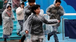 Participants run during an anti-missile evacuation drill at the Tokyo Dome City amusement park in Tokyo, Japan January 22, 2018.