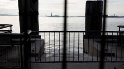 The Statue of Liberty is seen through fencing from a ferry dock following a U.S. government shutdown in Manhattan, New York, U.S., January 21, 2018.