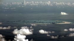 An aerial photo taken though a glass window of a Philippine military plane shows the alleged on-going land reclamation by China on Mischief Reef in the Spratly Islands in the South China Sea, west of Palawan, Philippines, May 11, 2015.