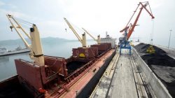 A cargo ship is loaded with coal during the opening ceremony of a new dock at the North Korean port of Rajin July 18, 2014.