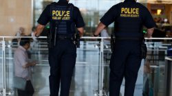 Homeland Security personnel keep watch as travelers depart at Lindbergh Field airport in San Diego, California, U.S. July 1, 2016.