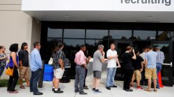 Job seekers line up to apply during "Amazon Jobs Day," a job fair being held at 10 fulfillment centers across the United States aimed at filling more than 50,000 jobs, at the Amazon.com Fulfillment Center in Fall River, Massachusetts, U.S., August 2, 2017.