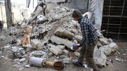 A man is seen near the remains of a rocket in Douma, Eastern Ghouta in Damascus, Syria January 22, 2018.