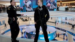 Policemen talk as a Super Bowl promotional banner showing Philadelphia Eagles quarterback Nick Foles and New England Patriots quarterback Tom Brady hangs in an atrium at the Mall of America in Minneapolis, Minnesota, U.S. January 29, 2018