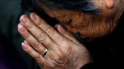 A believer prays during a weekend mass at an underground Catholic church in Tianjin in November 10, 2013.