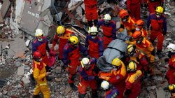 A body of a Hong Kong Canadian is carried out from a collapsed building after an earthquake hit Hualien, Taiwan February 9, 2018.