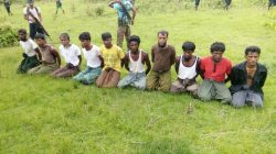 Ten Rohingya Muslim men with their hands bound kneel as members of the Myanmar security forces stand guard in Inn Din village September 2, 2017.