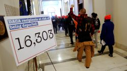 Demonstrators calling for new protections for so-called "Dreamers," undocumented children brought to the U.S. by their immigrant parents, walk through a senate office building on Capitol Hill in Washington, U.S. January 17, 2018. REUTERS/Jonathan Ernst