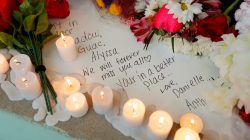 A handwritten note to a lost friend is surrounded by candles and flowers at a candlelight vigil the day after a shooting at Marjory Stoneman Douglas High School in Parkland, Florida, February 15, 2018. REUTERS/Jonathan Drake