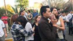 People stand on the street after an earthquake shook buildings in Mexico City, Mexico February 16, 2018.