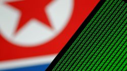 Binary code is seen on a screen against a North Korean flag in this illustration photo November 1, 2017. REUTERS/Thomas White/Illustration