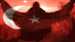 A demonstrator holds a Turkish flag outside the Turkish consulate in Rotterdam where a crowd gathered to await the arrival of the Turkish Family Minister Fatma Betul Sayan Kaya, who decided to travel to Rotterdam by land after Turkish Foreign Minister Mevlut Cavusoglu's flight was barred from landing by the Dutch government, in Rotterdam, Netherlands March 11, 2017. REUTERS/Dylan Martinez