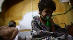 A child and a man are seen in hospital in the besieged town of Douma, Eastern Ghouta, Damascus, Syria February 25, 2018. REUTERS/Bassam Khabieh