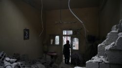 FILE PHOTO: A man inspects a damaged house in the besieged town of Douma in eastern Ghouta in Damascus, Syria, February 22, 2018. REUTERS/Bassam Khabieh