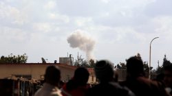 People watch as smoke rises in eastern Ghouta, Damascus, Syria February 28, 2018. REUTERS/Omar Sanadiki